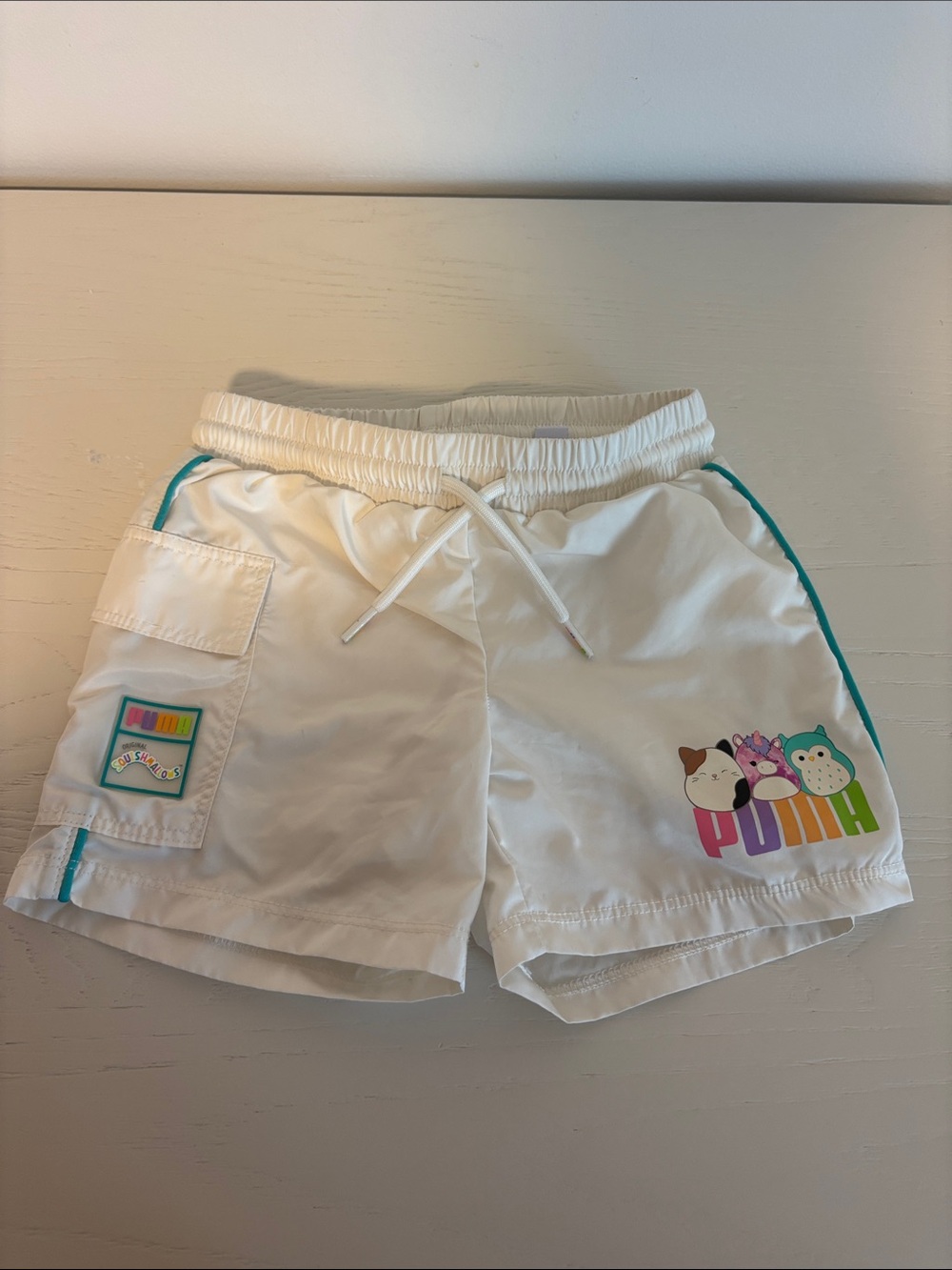 Puma White Kids Shorts with Colorful Cartoon Logo and Teal Trim